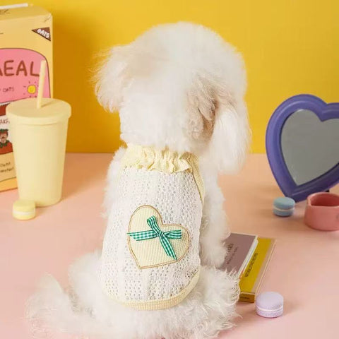 Image of a dog wearing the green variant of Heart Bow Summer Pet Sweater - Pets Villa.