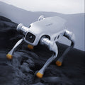 White robot-like creature on a dark, textured surface with a gray background