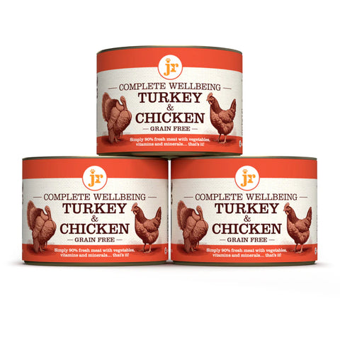 Image of the cans of JR Dog Complete Wellbeing Turkey & Chicken 200g stacked - Pets Villa. 