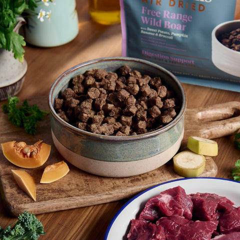 Image of a table with a bowl of MCADAMS Dog Complete Air Dried Free Range Wild Boar Dry Food - Pets Villa.